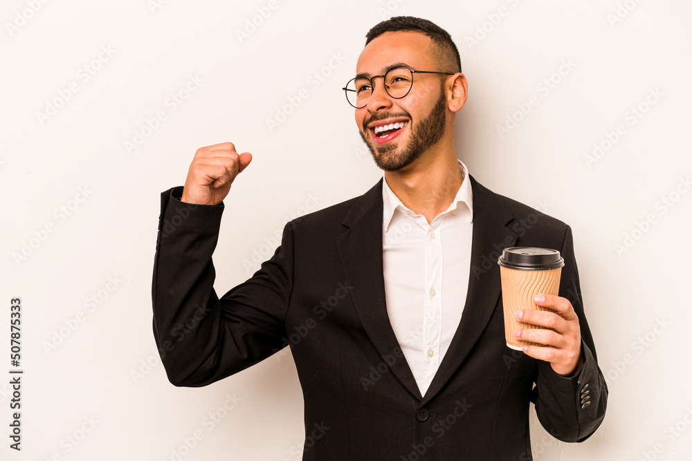 Young business hispanic man holding takeaway coffee isolated on white background raising fist after a victory, winner concept.