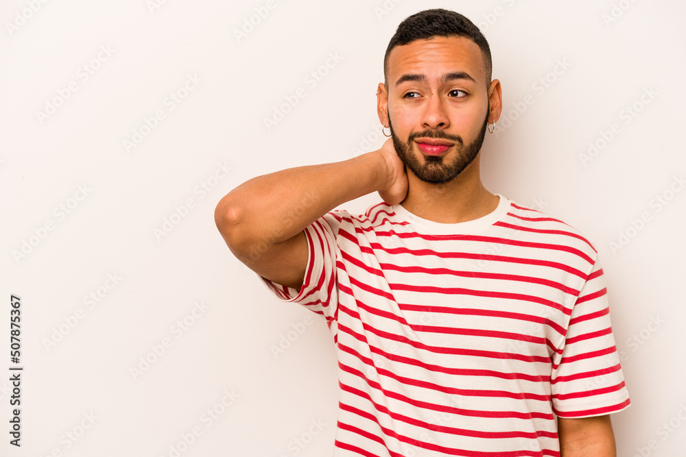 Young hispanic man isolated on white background touching back of head, thinking and making a choice. Young hispanic man isolated on white background touching back of head, thinking and making a choice.