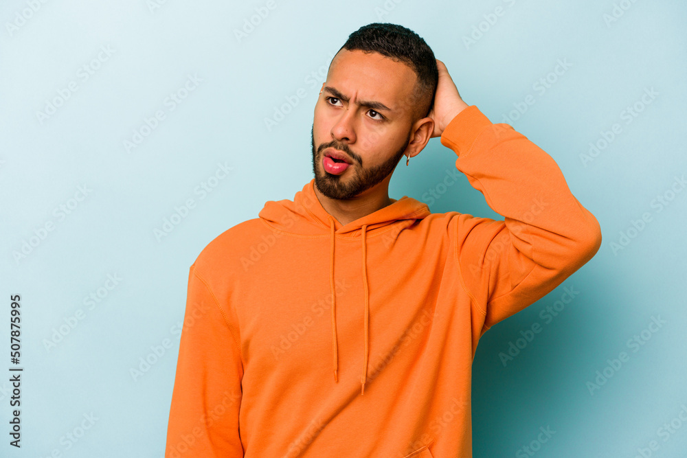 Young hispanic man isolated on blue background being shocked, she has remembered important meeting.
