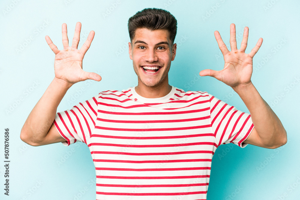 Young caucasian man isolated on blue background showing number ten with hands. Young caucasian man isolated on blue background showing number ten with hands.