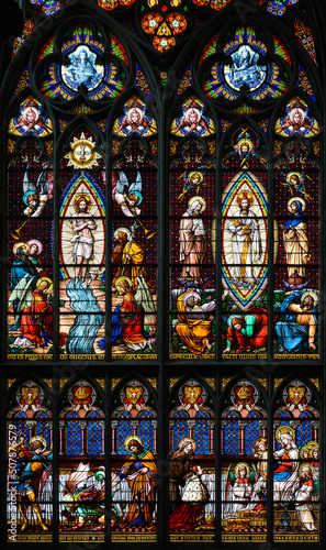 tained-glass window  Above  Baptism of Jesus and His Transfiguration. Below  the emperor Franz Joseph in front of the Virgin Mary and Jesus. Votivkirche     Votive Church  Vienna  Austria. 2020-07-29. 