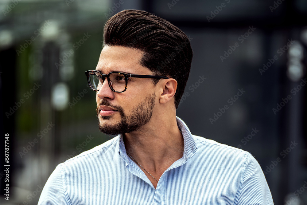 Handsome businessman using mobile phone app outside of office. Successful man holding smartphone for business work. Handsome businessman using mobile phone app outside of office. Successful man holding smartphone for business work.
