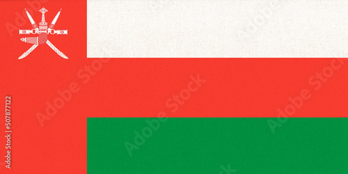 Flag of Sultanate of Oman. Fabric Texture. National symbol. photo