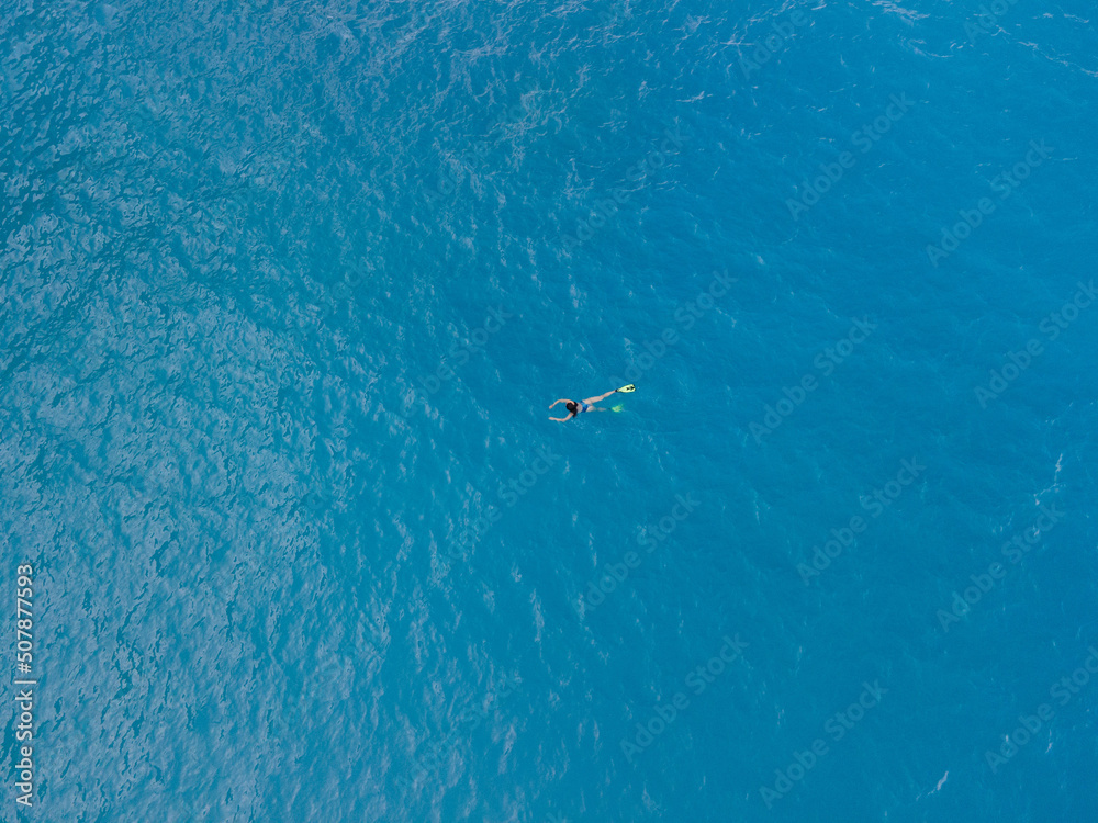 overhead view of woman swimming in flippers