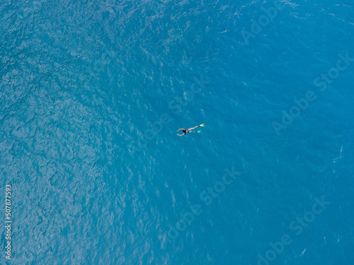 overhead view of woman swimming in flippers © phpetrunina14