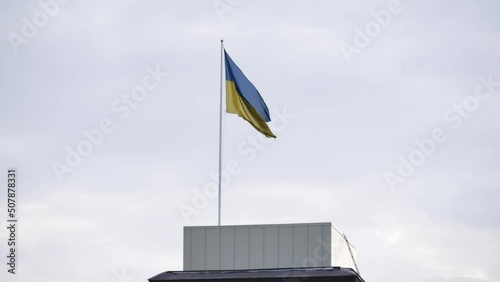 Ukrainian national flag is unfolding in the wind with the sky background