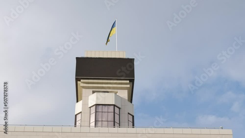 Ukrainian national flag is unfolding in the wind with the sky background