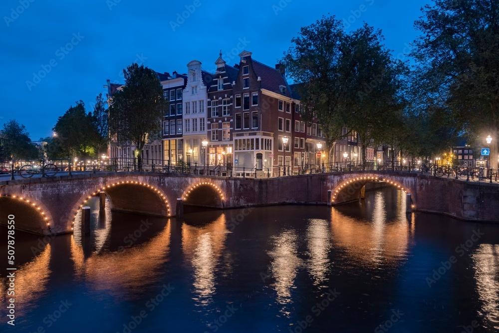 Amsterdam, Netherlands bridges and canals at twilight. 