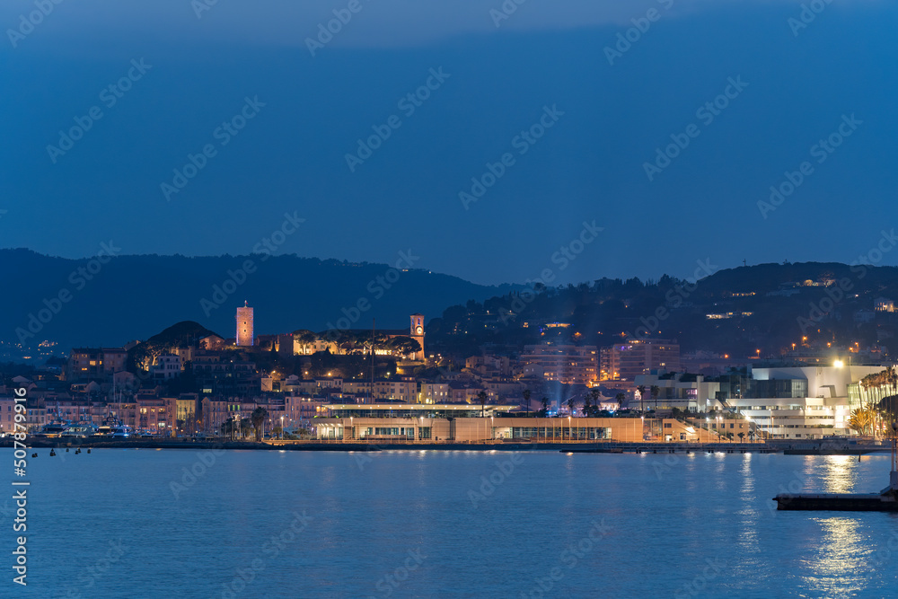 View of sea port in Cannes,France and its old town during the blue hour