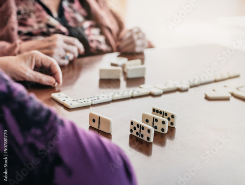 Fotografie close-up of two elderly people playing dominoes
