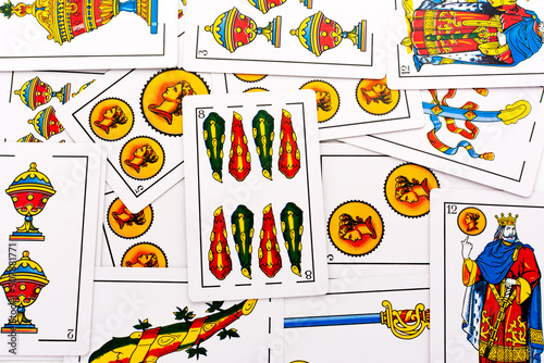 Spanish card game, spanish deck Tarot cards, the wands card in the foreground.