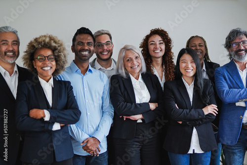 Group of happy multiethnic business people smiling on camera inside office