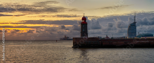 scenic sunset panorama over the lighthouse Geestemole Nord in Bremerhaven, Germany photo