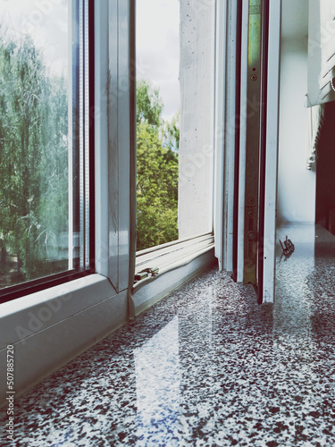 a large plastic window is open to ventilate the room