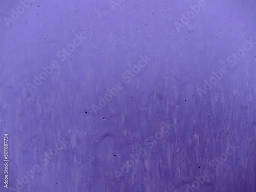 old faded background of purple paint on a wooden fence.