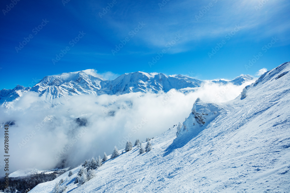 View of the Mont Blanc massif mountain range over clouds View of the Mont Blanc massif mountain range over clouds