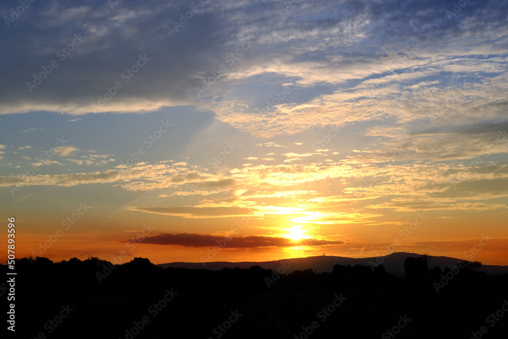 sunset in evening beautiful dramatic sky with cloud, background light sky gradient, concept of heavenly space, abode of God, meditative calmness and greatness, black silhouette of hills at bottom