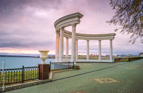 Beautiful white rotunda overlooking the Izhevsk pond in autumn
