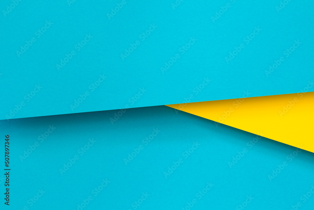 Abstract color papers geometry flat lay composition background with blue and yellow tones