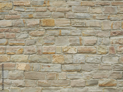 Facade wall with masonry of not the same rectangular bricks. Full-screen image. Not seamless texture