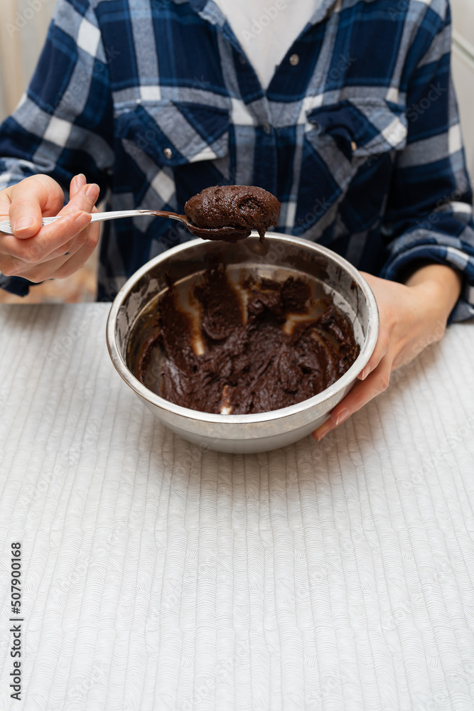 Preparation for baking chocolate brownie, dough in a metal bowl. Cooking cookies at home. Preparation for baking chocolate brownie, dough in a metal bowl. Cooking cookies at home.
