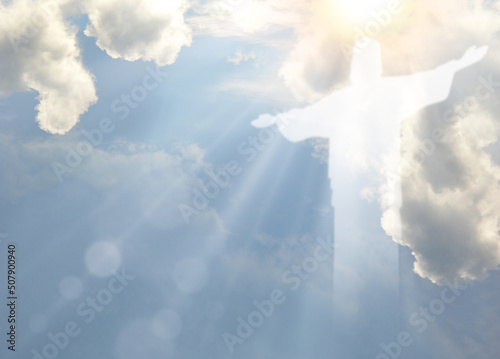 Ascension of Christ. Shining silhouette in the clouds photo