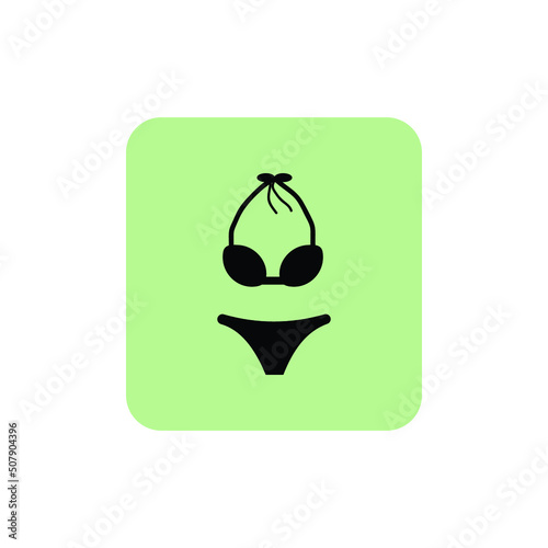 Swimsuit vector icon on green isolated background.