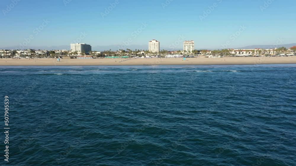 Drone Aerial Over the Pacific Ocean at Huntington Beach California Flying Toward Beach Coastline Drone Aerial Over the Pacific Ocean at Huntington Beach California Flying Toward Beach Coastline