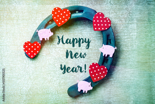 Happy New Year decoration with horseshoe hearts and good luck