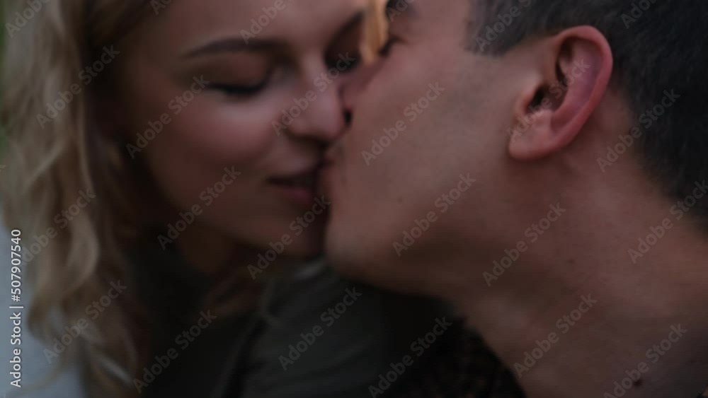 Woman feed a man with orage peace in the forest camping. Love story outdoor Woman feed a man with orage peace in the forest camping. Love story outdoor