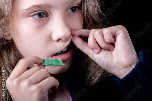 snus. tobacco in bags. a female child uses nicotine. close-up