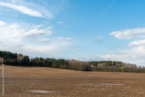 Rows of soil before planting. Drawing of furrows on a plowed field prepared for spring sowing of agricultural crops. View of the land prepared for planting and growing crops.