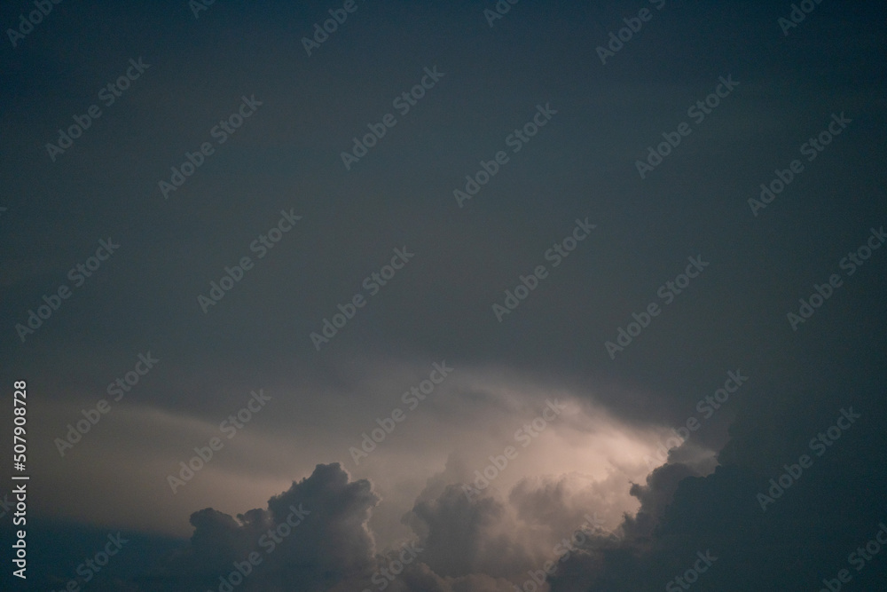 dark clouds and thunderstorm in the Bavarian Forest with bright sheet lightning