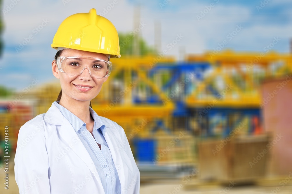 Invest in new development. Portrait of a young woman working at a construction site. Invest in new development. Portrait of a young woman working at a construction site.