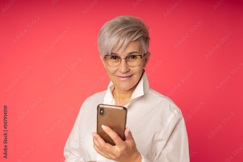 stylish adult woman with a mobile phone in her hand stylish adult woman with a mobile phone in her hand