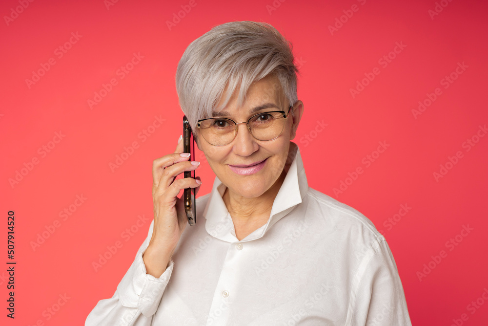 mature businesswoman in glasses calling by phone mature businesswoman in glasses calling by phone
