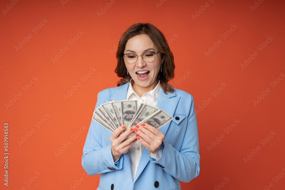 joyful adult businesswoman with dollars in her hands joyful adult businesswoman with dollars in her hands