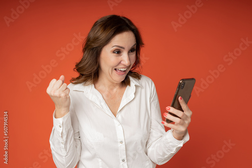 joyful woman with a mobile phone in her hand