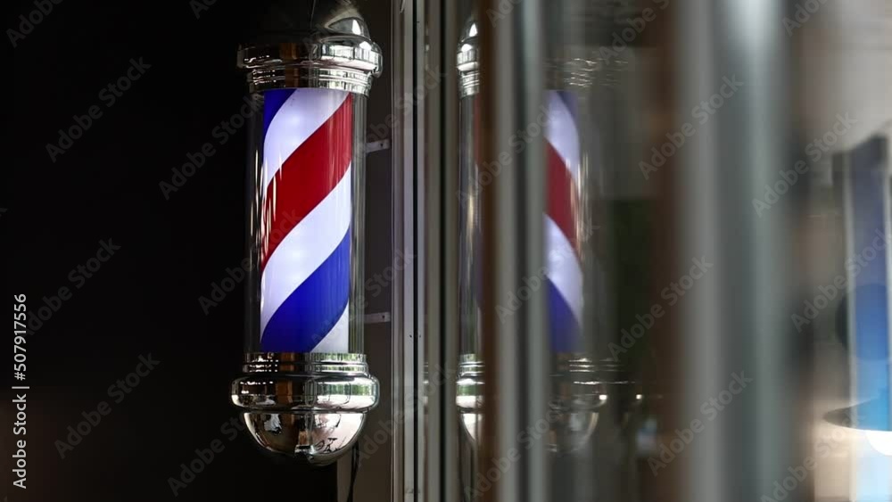 Barber shop vintage pole. copyspace Barbershop. Barber shop pole in red white and blue with lightbulb on top