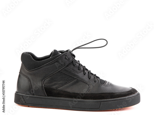 Black leather classic sneakers with laces. Casual women's style. Black rubber soles. Isolated close-up on white background. Right side view.