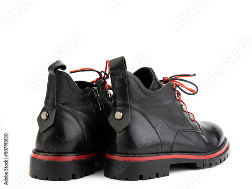 Women's autumn black and red leather jodhpur boots with laces and average heels, isolated white background. Back side view. Fashion shoes.