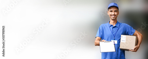 Male courier holding parcel...
