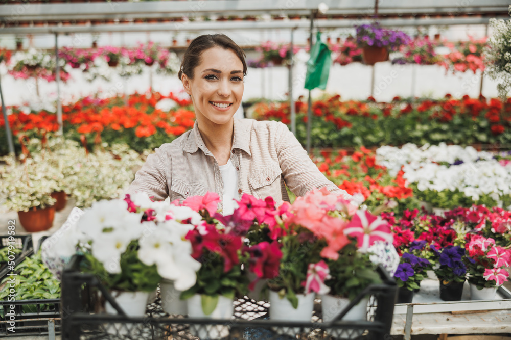 Woman With Flowers In Garden Center