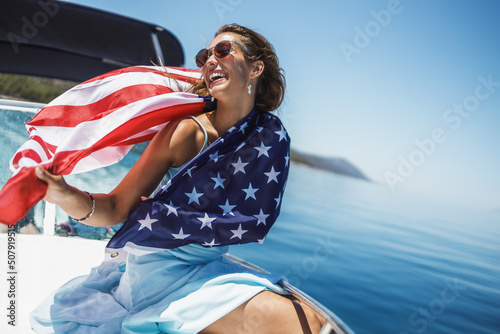 Woman With US National Flag Spending Day On Private Yacht photo