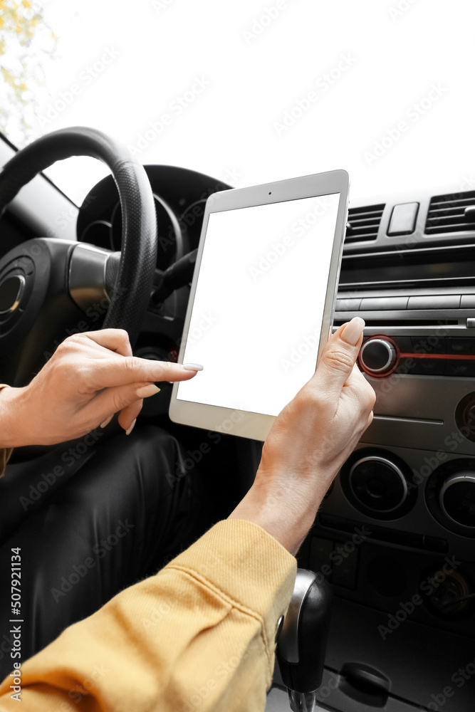Female driver using tablet computer for navigation Female driver using tablet computer for navigation
