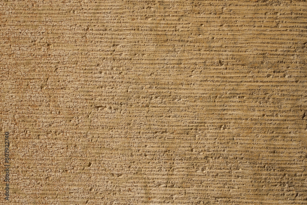 An antique concrete wall is light brown as a background. An antique concrete wall is light brown as a background.