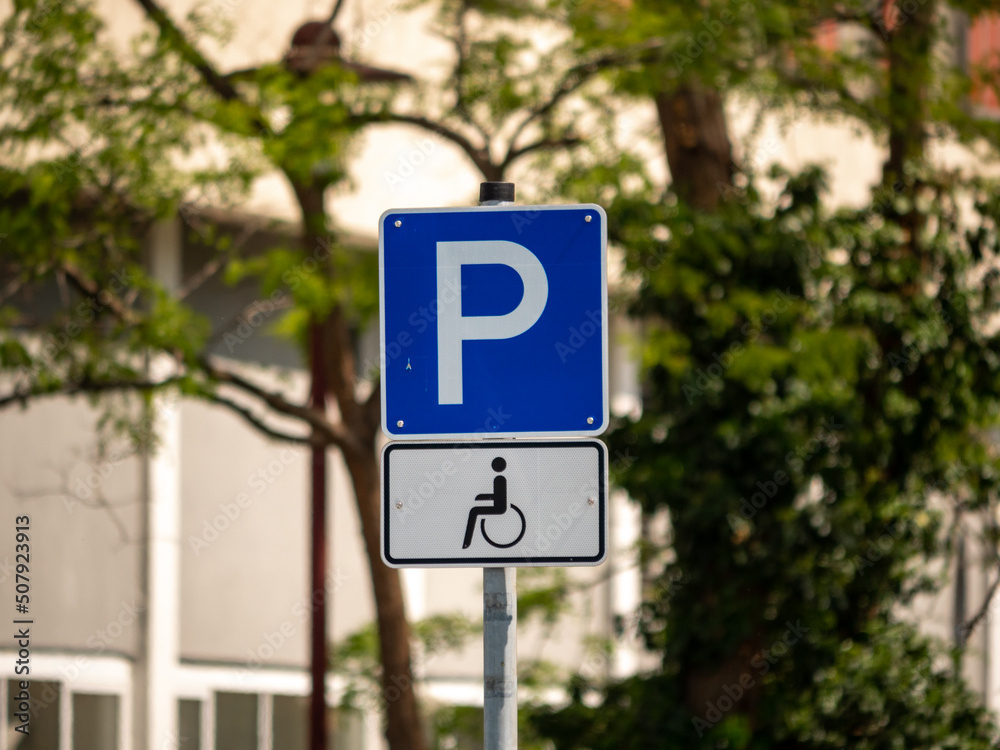 Disabled parking lot traffic sign. Street symbol with a wheelchair. Extra place to park a car for people that are handicapped. This place is the most accessible area to park a car. Disabled parking lot traffic sign. Street symbol with a wheelchair. Extra place to park a car for people that are handicapped. This place is the most accessible area to park a car.