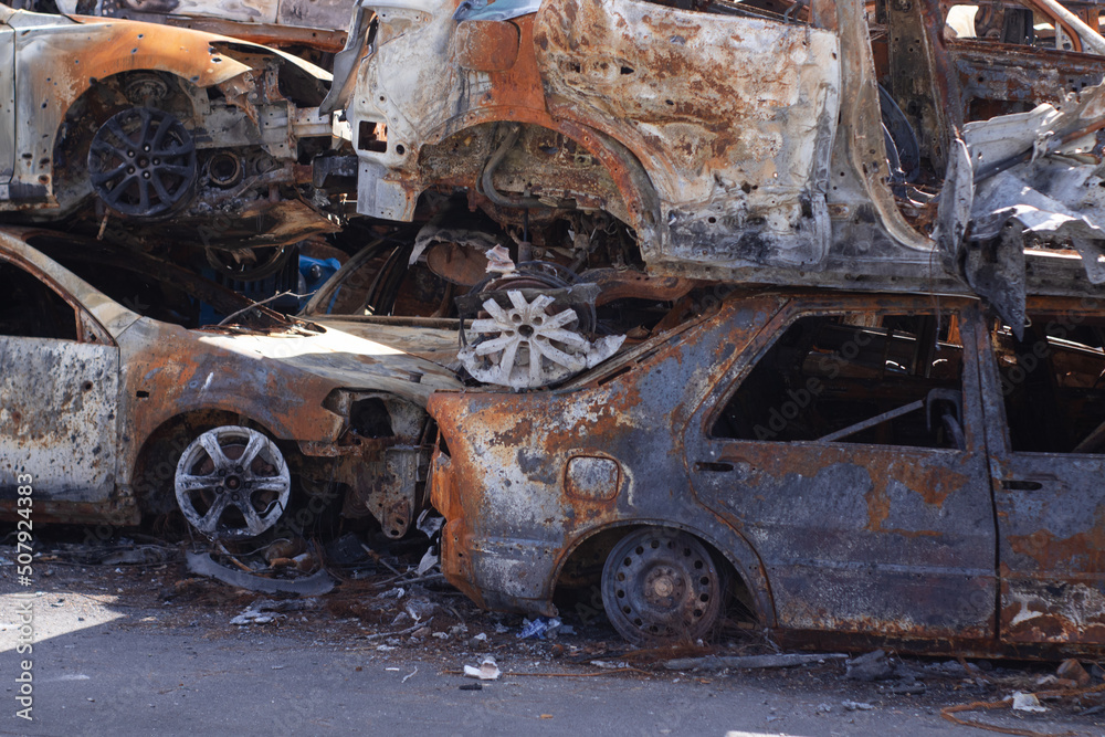 war in ukraine. Car graveyard. Shot cars of civilians. russia's war against Ukraine. Burnt and blown up car. Cars damaged after shelling. irpin bucha. war crimes war in ukraine. Car graveyard. Shot cars of civilians. russia's war against Ukraine. Burnt and blown up car. Cars damaged after shelling. irpin bucha. war crimes