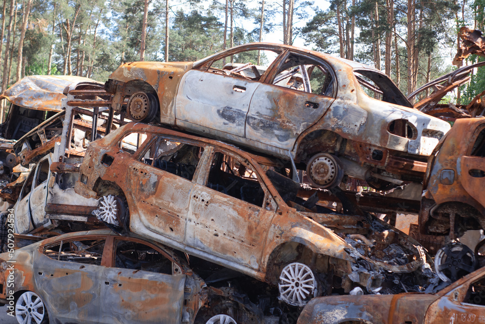 war in ukraine. Car graveyard. Shot cars of civilians. russia's war against Ukraine. Burnt and blown up car. Cars damaged after shelling. irpin bucha. war crimes