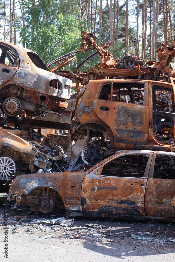 war in ukraine. Car graveyard. Shot cars of civilians. russia's war against Ukraine. Burnt and blown up car. Cars damaged after shelling. irpin bucha. war crimes
